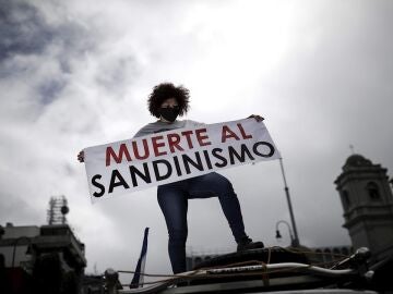 Una persona muestra un cartel que rechaza al Sandinismo durante una manifestación contra las elecciones presidenciales de Nicaragua