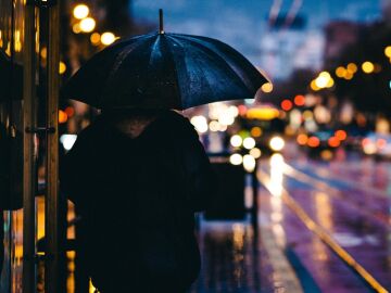 Una persona camina bajo la lluvia