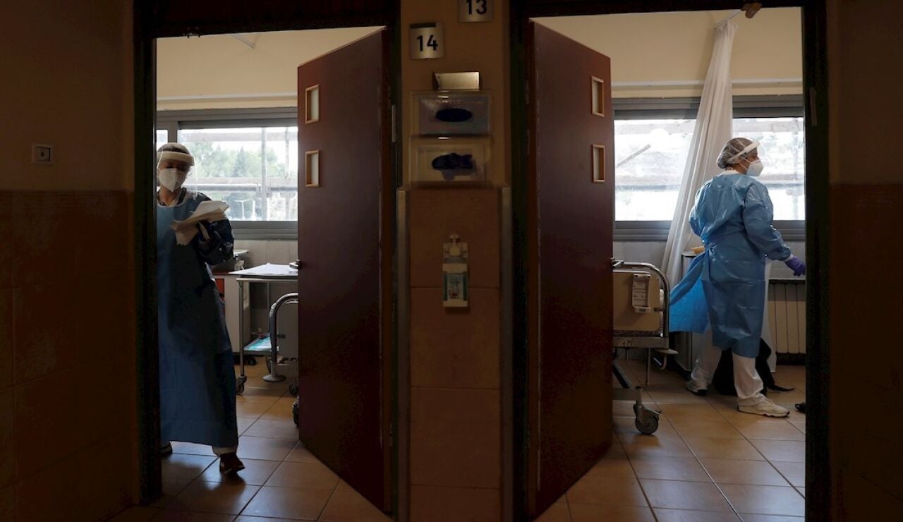 Dos sanitarias en un hospital atienden a pacientes de Covid, foto de archivo