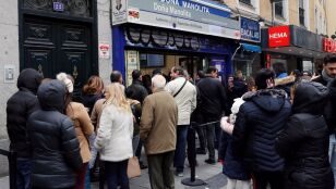 Varias personas hacen cola frente a la administraci&oacute;n de loter&iacute;a Do&ntilde;a Manolita, en Madrid