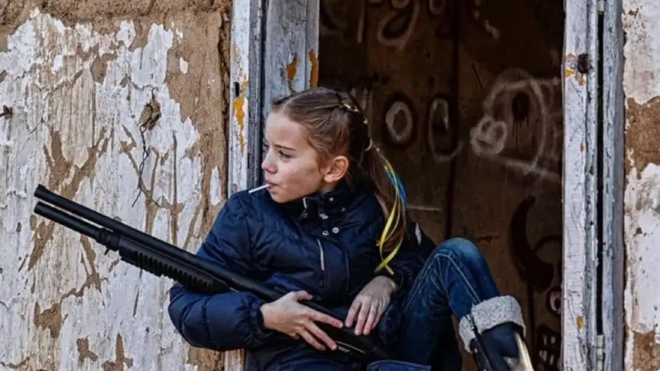 La dura imagen de una niña con una piruleta y un fusil de asalto que refleja la realidad de los más jóvenes en Ucrania La dura imagen de una niña con una piruleta y un fusil de asalto que refleja la realidad de los más jóvenes en Ucrania