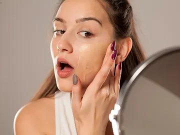 Chica aplicándose base Chica aplicándose base