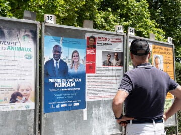 Un hombre observa los candidatos en la segunda vuelta en las elecciones legislativas francesas, el pasado viernes.