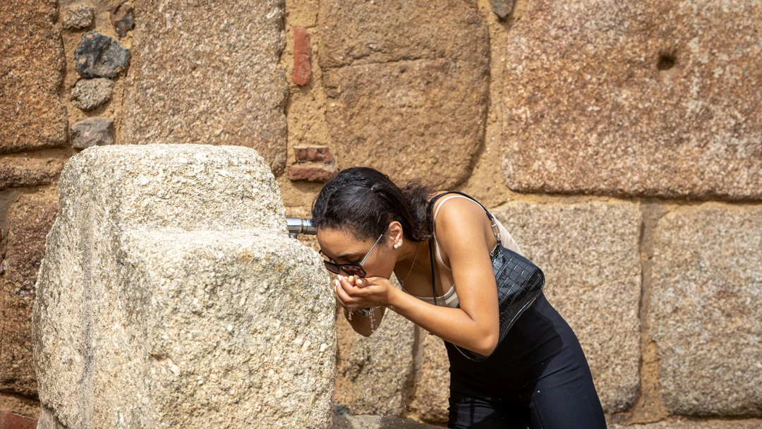 La joven bebió agua de una fuente La joven bebió agua de una fuente