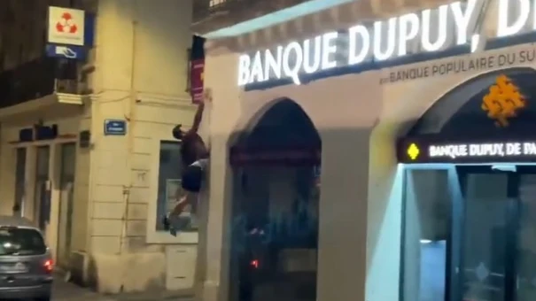Un practicante de parkour apagan un cartel de un comercio en Francia Un practicante de parkour apagan un cartel de un comercio en Francia