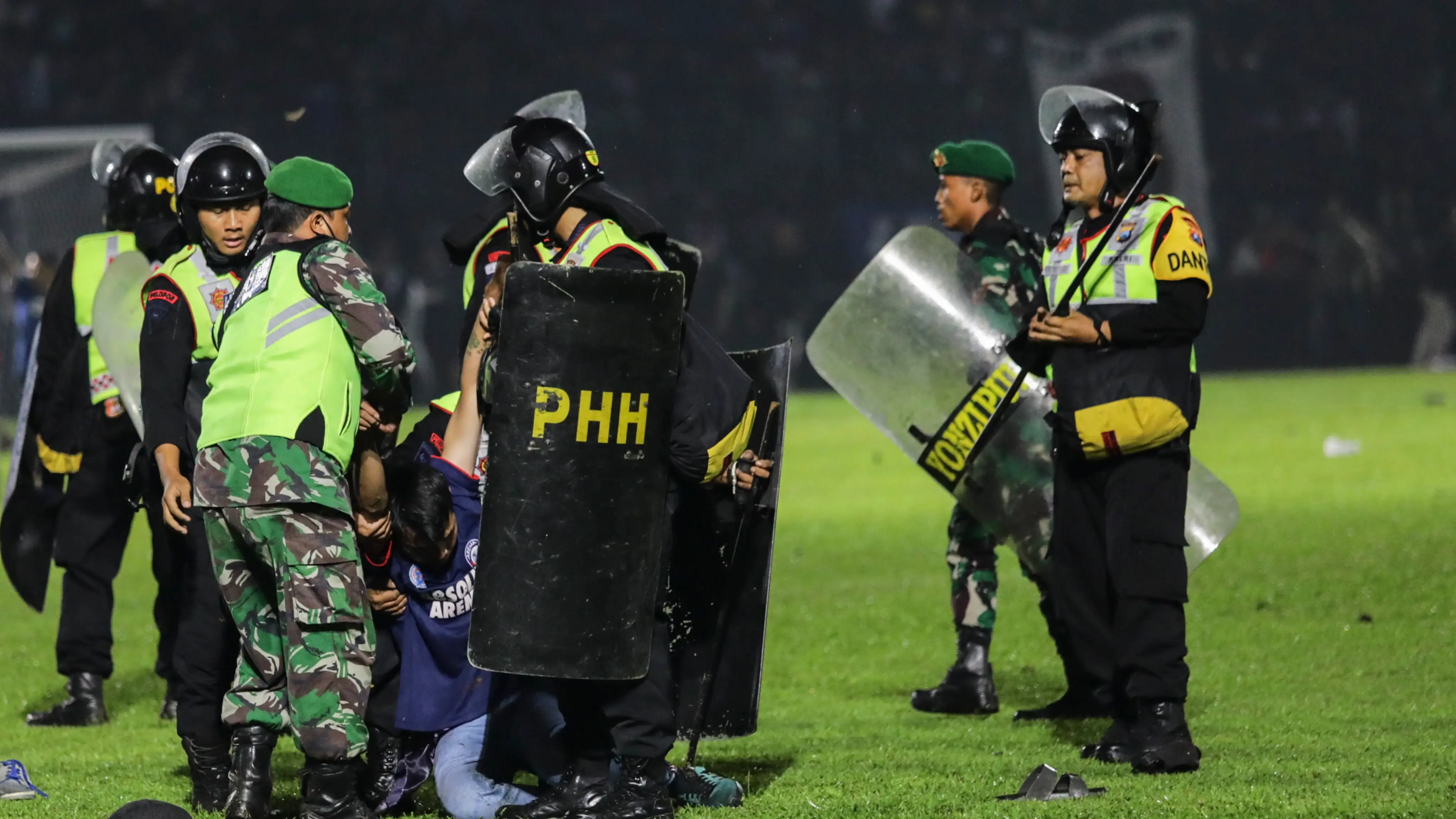 Agentes de policía detienen a un aficionado en el Kanjuruhan Stadium, en Malang Agentes de policía detienen a un aficionado en el Kanjuruhan Stadium, en Malang