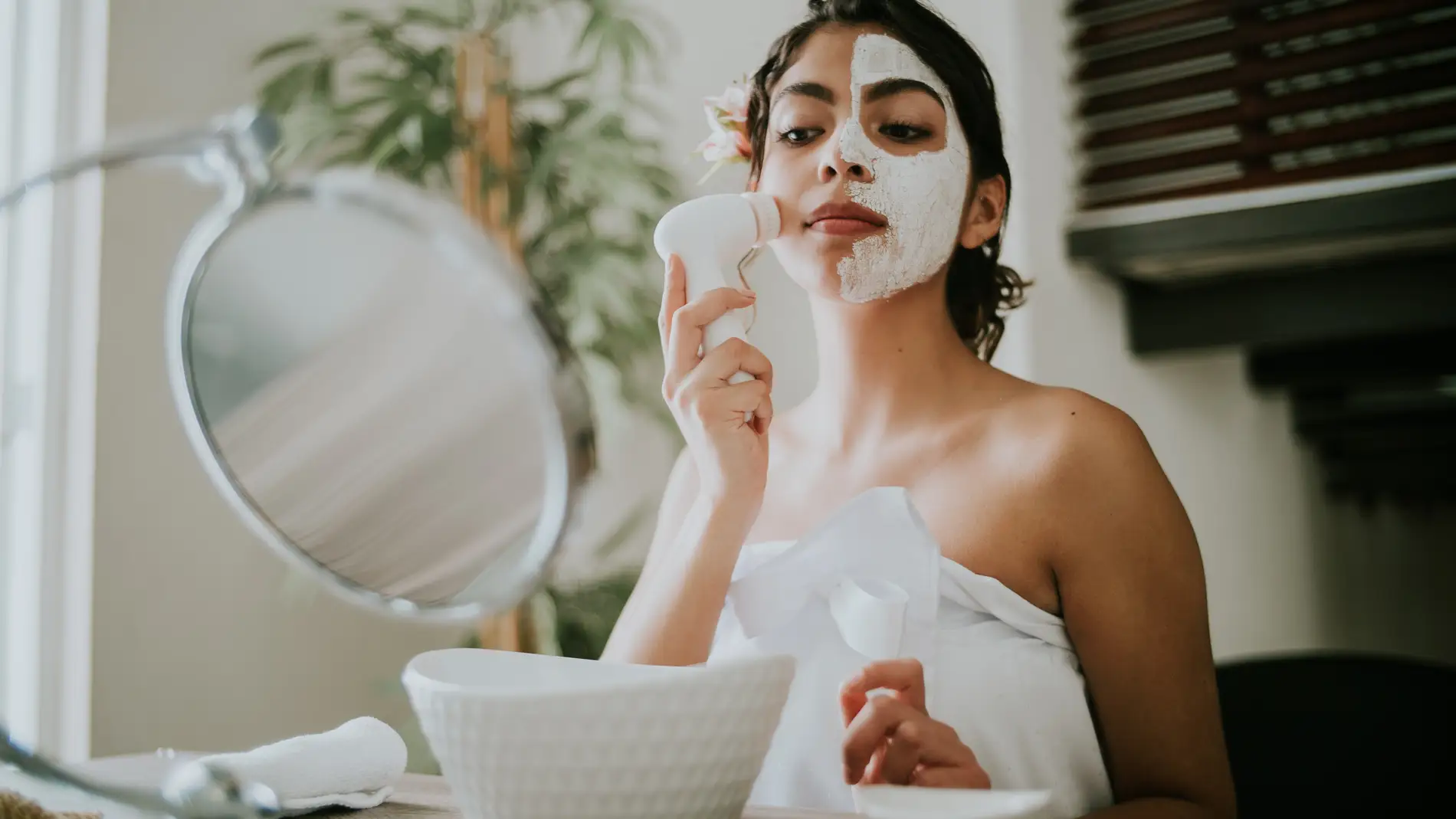 Mujer aplicándose mascarilla facial