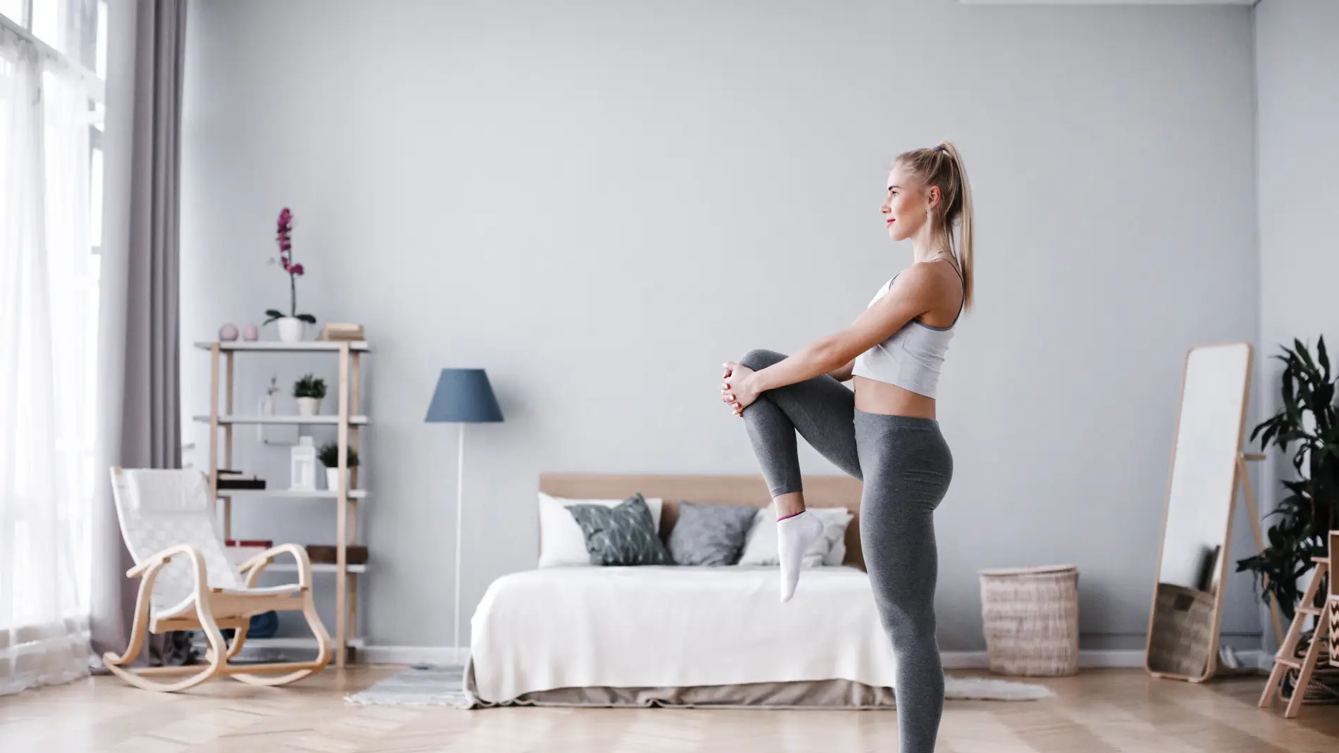 Una mujer entrena en casa sin material.