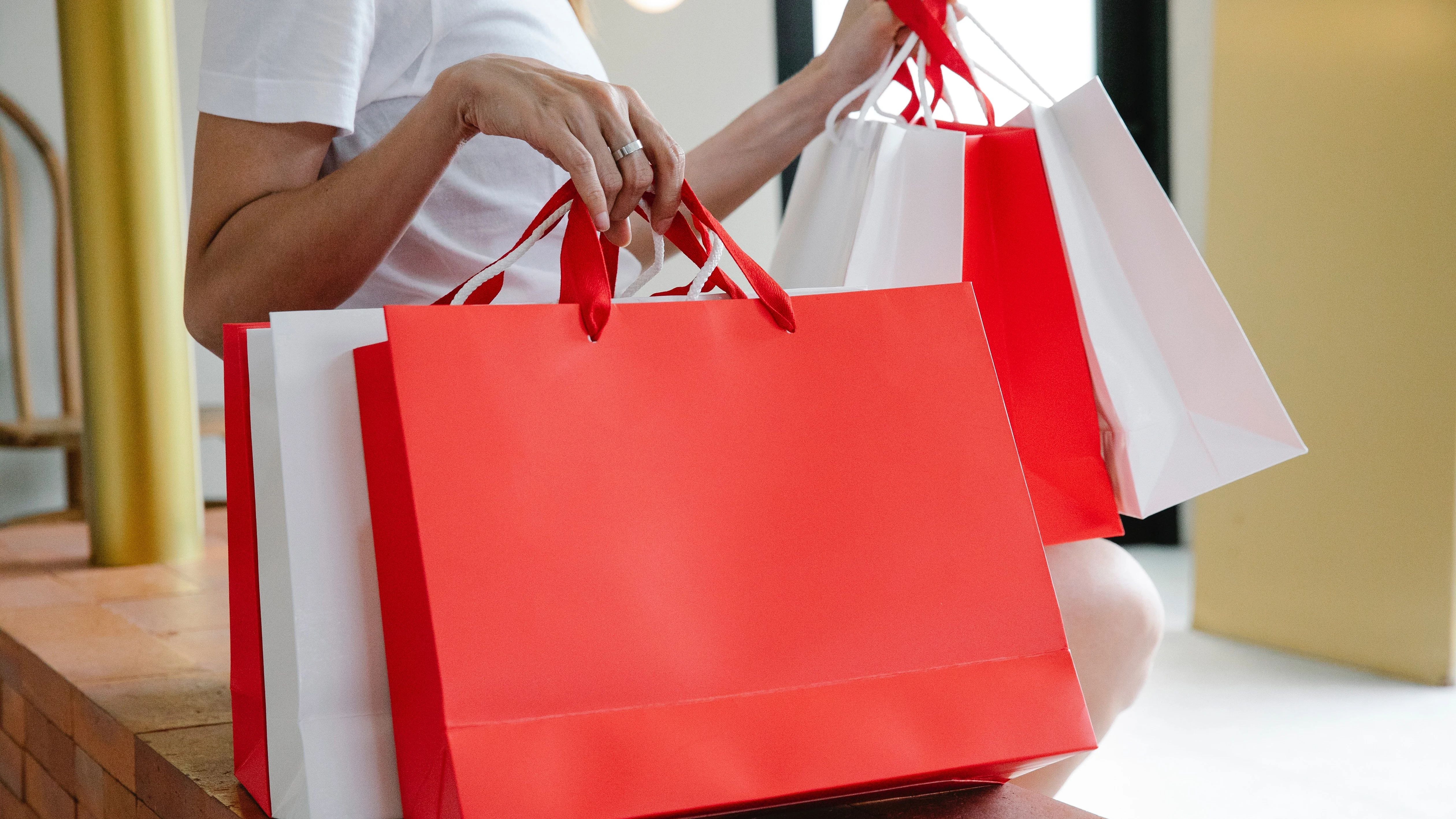 Persona con bolsas rojas y blancas Persona con bolsas rojas y blancas