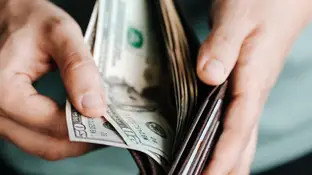 Imagen de archivo de una cartera con dinero Imagen de archivo de una cartera con dinero