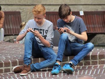 Dos adolescentes con el móvil 