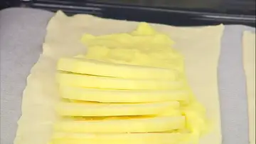 Corta las manzanas en láminas finas y distribúyelas (superponiéndolas) sobre la crema