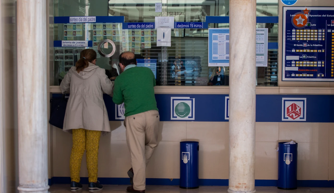 Dos personas comprando en una Administración de Lotería