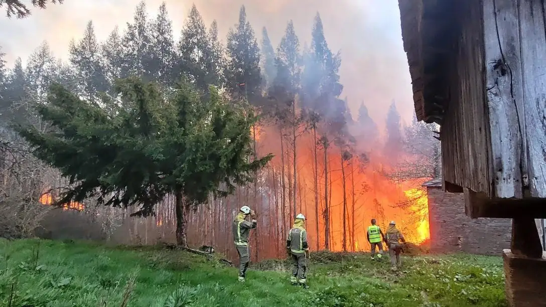 Bomberos luchando contra las llamas en un incendio forestal en Galicia