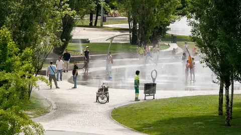 Varias personas disfrutan de los chorros de agua de Madrid Río Varias personas disfrutan de los chorros de agua de Madrid Río