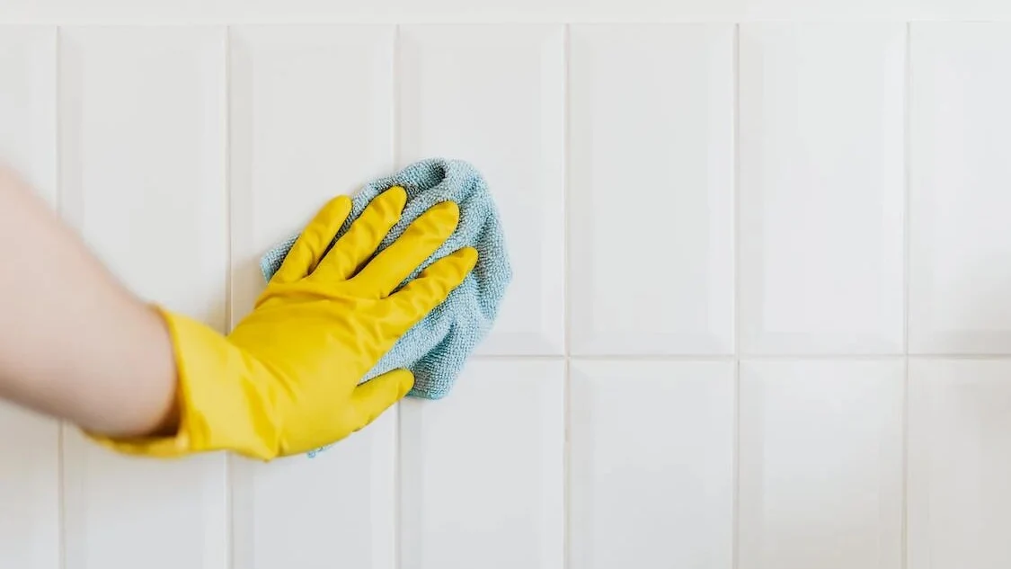 Lavando las juntas de las baldosas de la pared del baño Lavando las juntas de las baldosas de la pared del baño