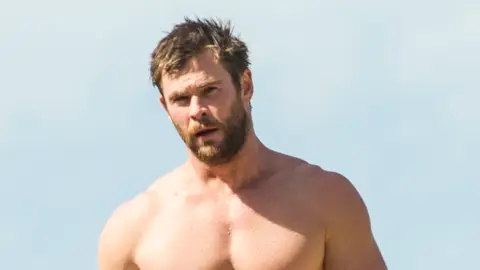 Chris Hemsworth en la playa sin camiseta tras hacer surf