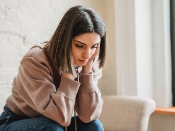 Mujer con la cabeza apoyada en las manos