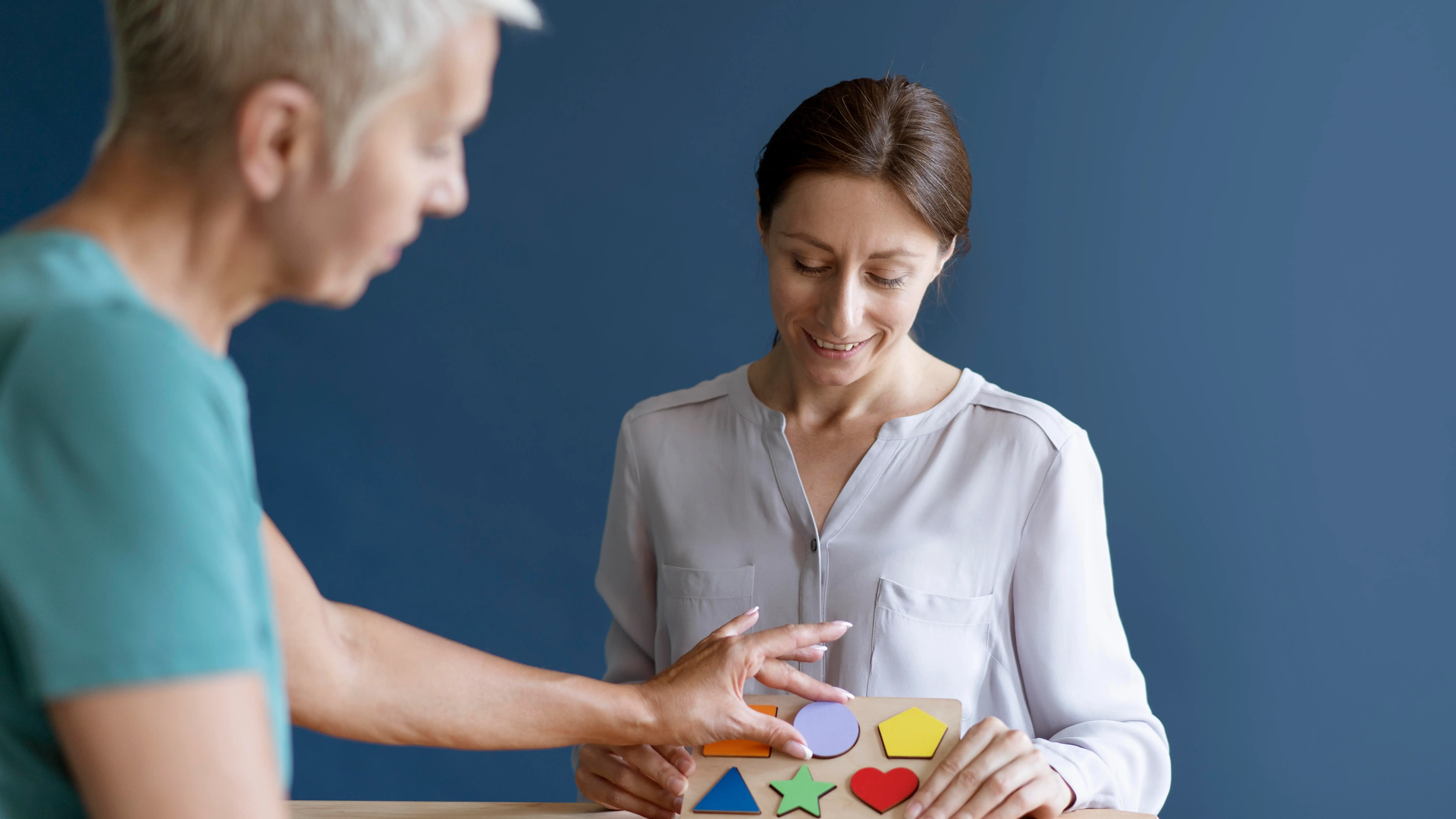 Mujer haciendo una sesi&oacute;n de terapia ocupacional con un psic&oacute;logo