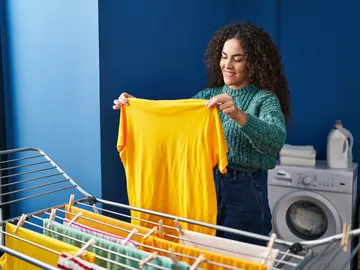 Una mujer tendiendo la ropa Una mujer tendiendo la ropa