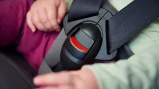 Bebé en una sillita en un coche Bebé en una sillita en un coche