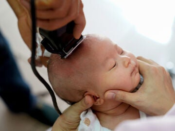 Corte de pelo con máquina a un bebé recién nacido