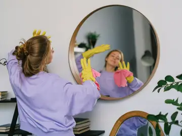 Una persona limpiando la casa con guantes Una persona limpiando la casa con guantes