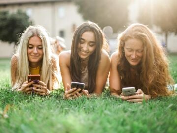 Tres chicas mirando el móvil