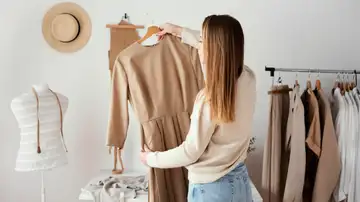 Mujer eligiendo prendas para su armario cápsula Mujer eligiendo prendas para su armario cápsula