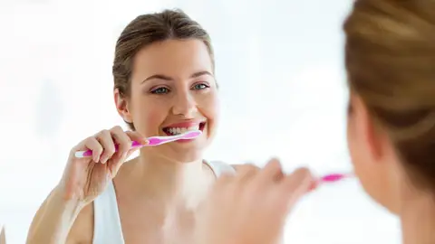Mujer lavándose los dientes Mujer lavándose los dientes