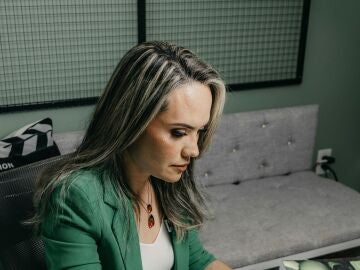 Una mujer escribiendo en un ordenador 