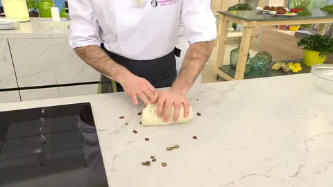 Pasa la masa a la encimera, añádele las aceitunas y el tomate Pasa la masa a la encimera, añádele las aceitunas y el tomate