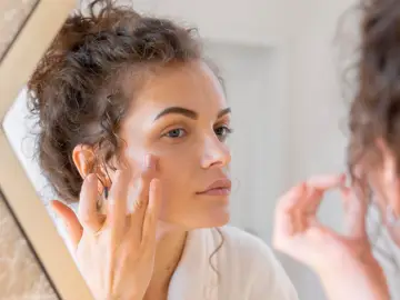 Mujer mirándose la piel Mujer mirándose la piel