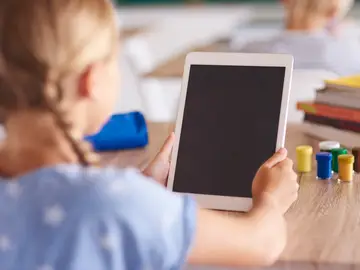 Una niña con una tablet en el colegio Una niña con una tablet en el colegio