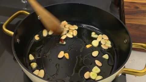 Agrega también las almendras y una guindilla, y fríelos 