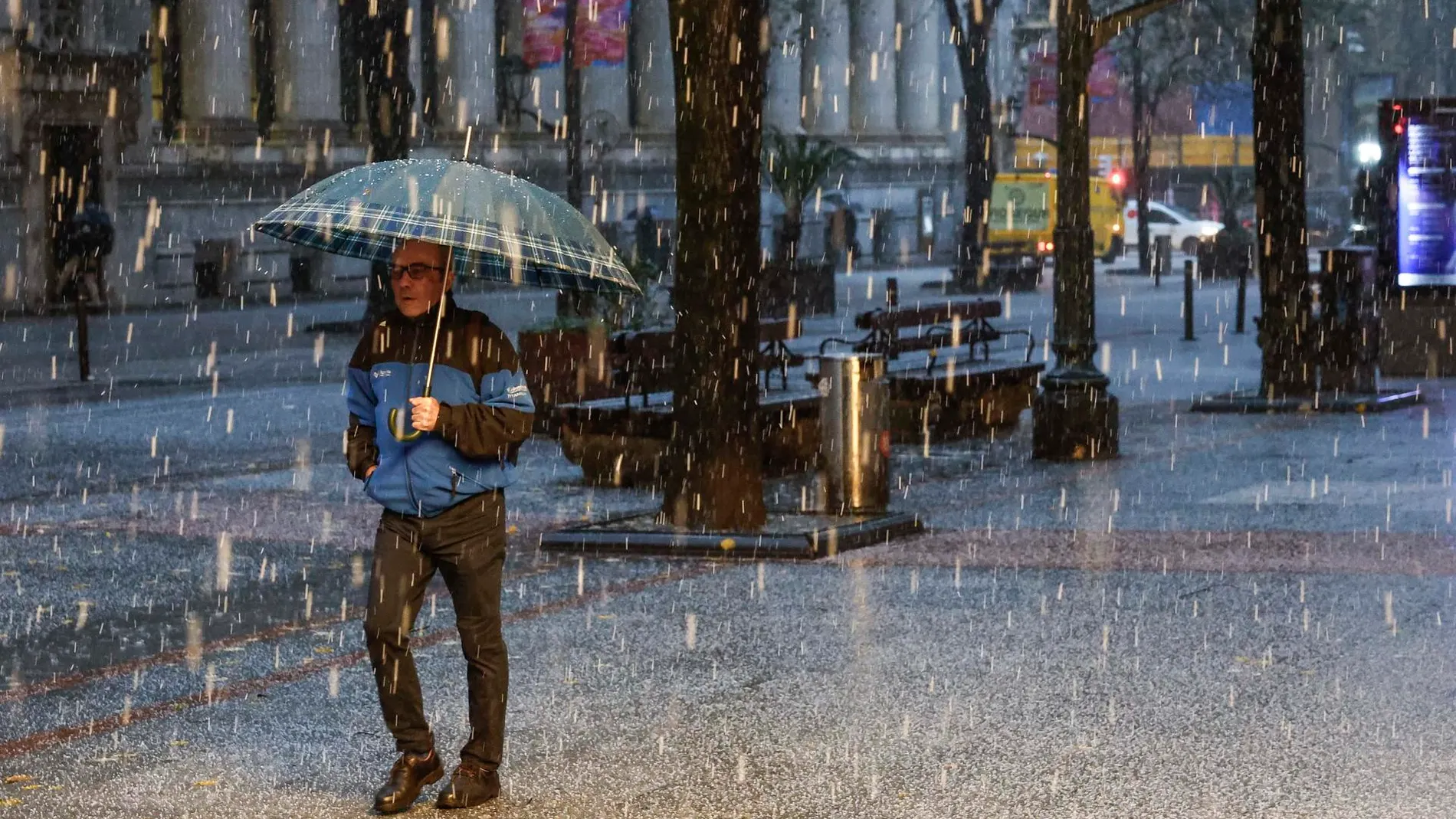 Imagen de un hombre protegiéndose de la granizada caída el viernes en Bilbao Imagen de un hombre protegiéndose de la granizada caída el viernes en Bilbao