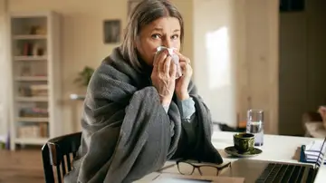 Una mujer resfriada con congestión nasal Una mujer resfriada con congestión nasal