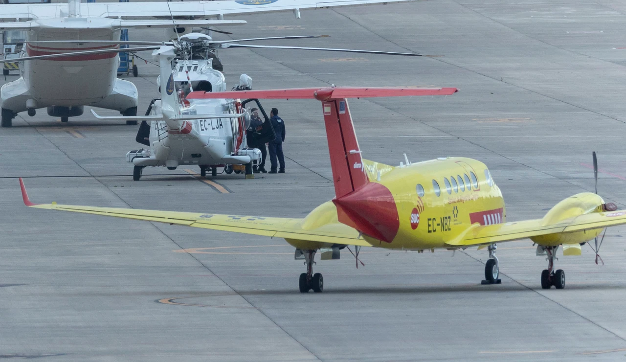 Aeronave del Servicio Canario de la Salud en el aeropuerto de Gran Canaria junto a un avión y un helicóptero de Salvamento Marítimo durante la estancia del avión ambulancia en la isla.