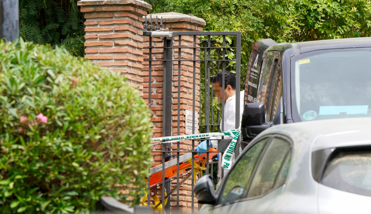Agentes Judiciales trasladan la camilla para sacar el cuerpo de la mujer de 45 a&ntilde;os ha sido hallada muerta